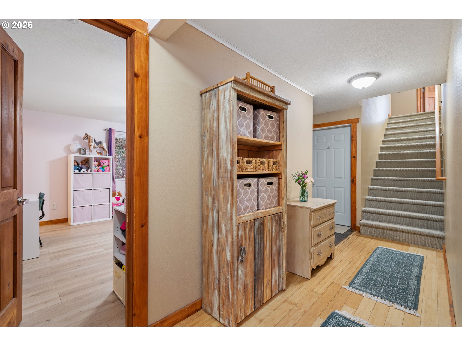 38220 Northeast Sunset Falls Road Yacolt, WA 98675 - Photo 21 of 40 a view of a hallway with wooden floor and furniture