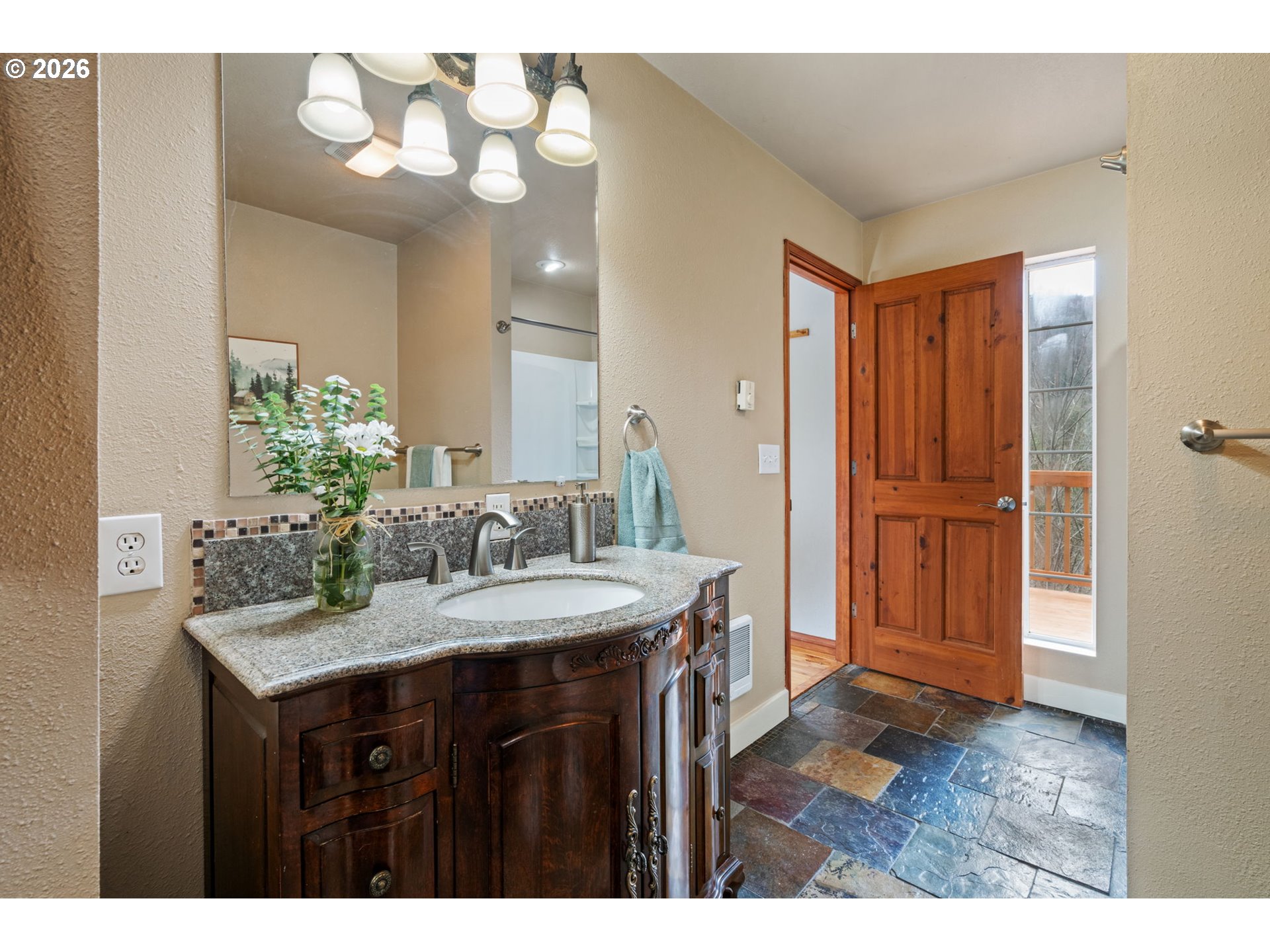 38220 Northeast Sunset Falls Road Yacolt, WA 98675 - Photo 24 of 40 a bathroom with a sink a vanity and a mirror