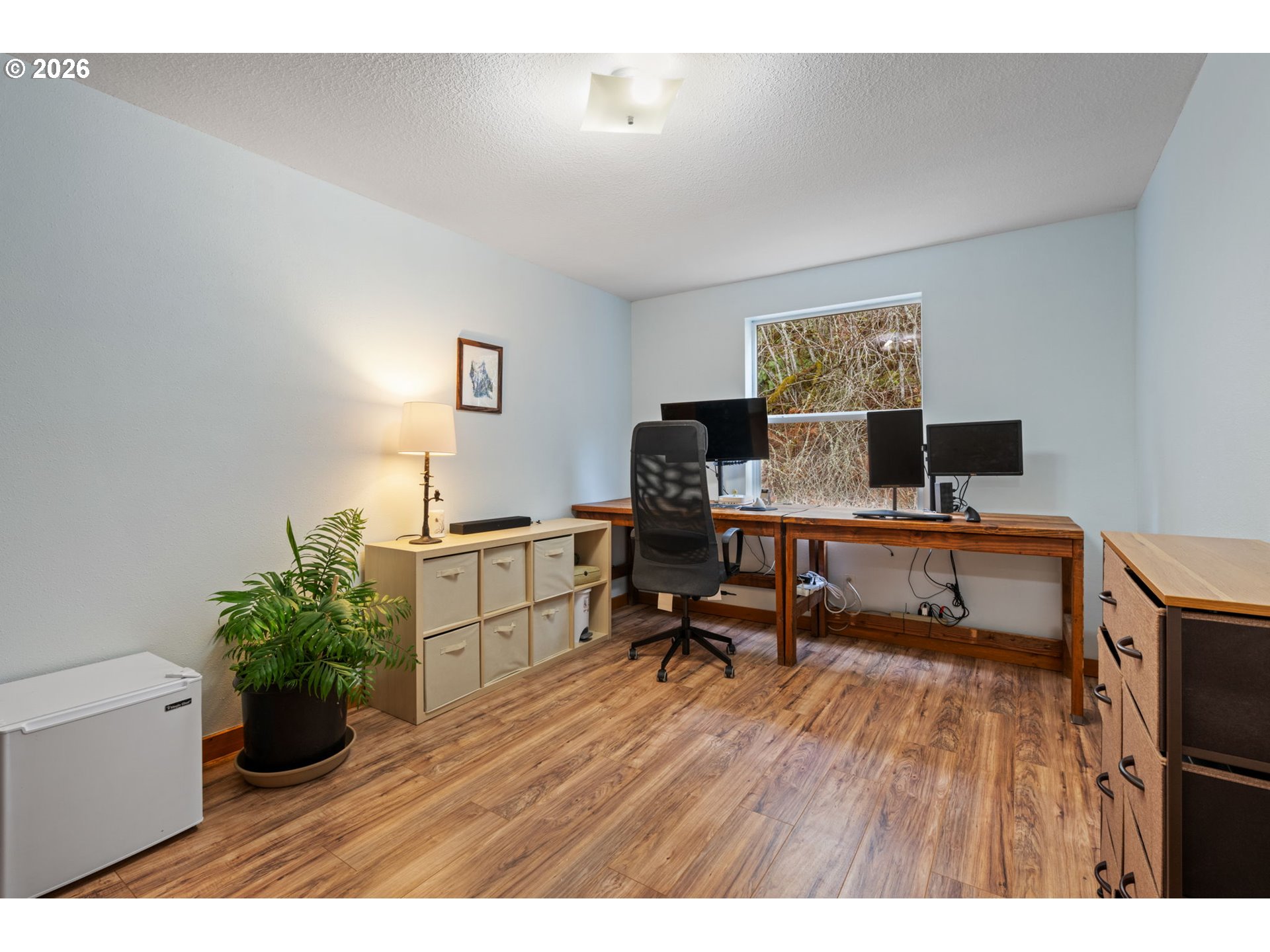 38220 Northeast Sunset Falls Road Yacolt, WA 98675 - Photo 28 of 40 a workspace with furniture and wooden floor