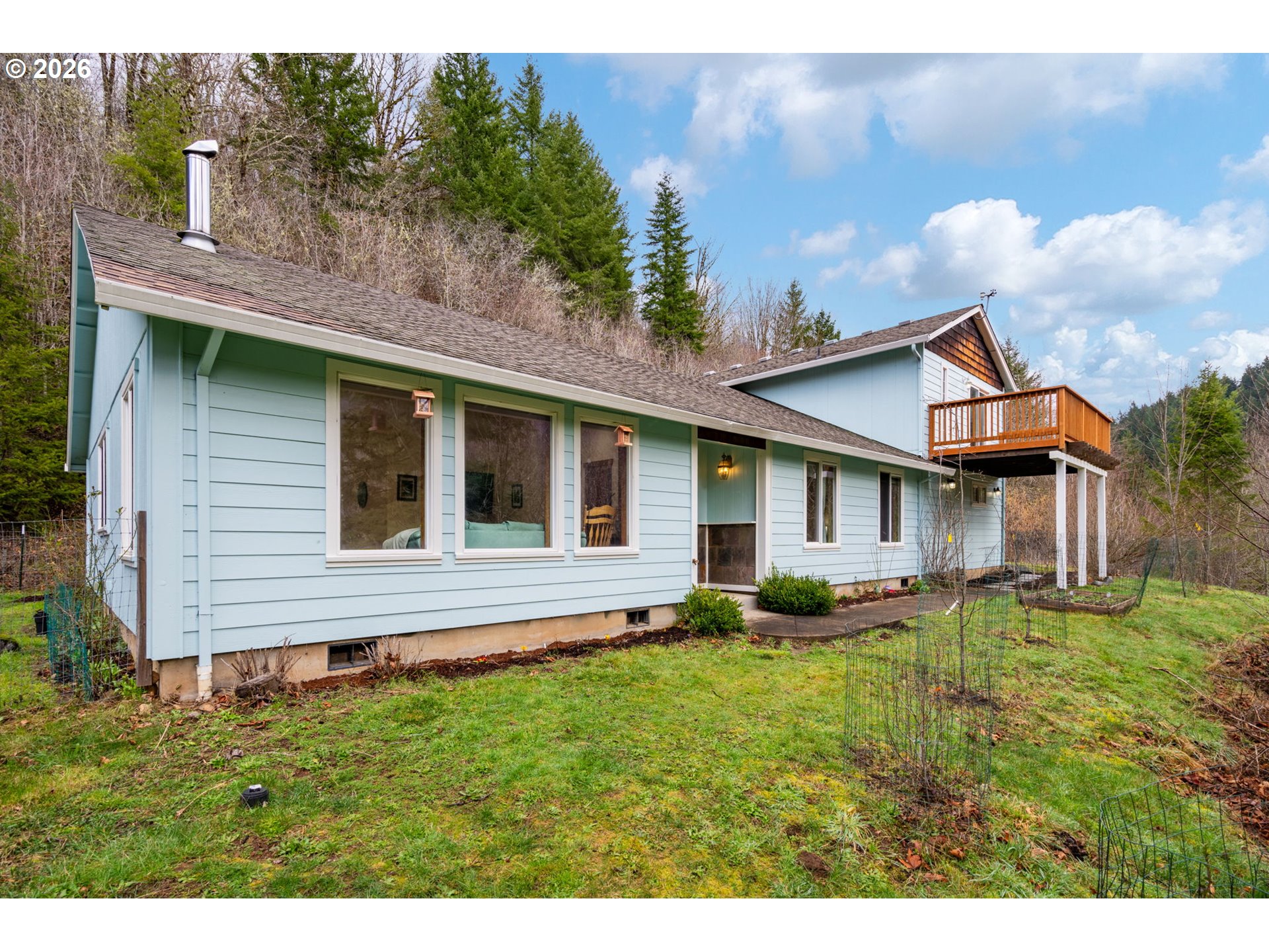 38220 Northeast Sunset Falls Road Yacolt, WA 98675 - Photo 3 of 40 a front view of a house with a yard and potted plants