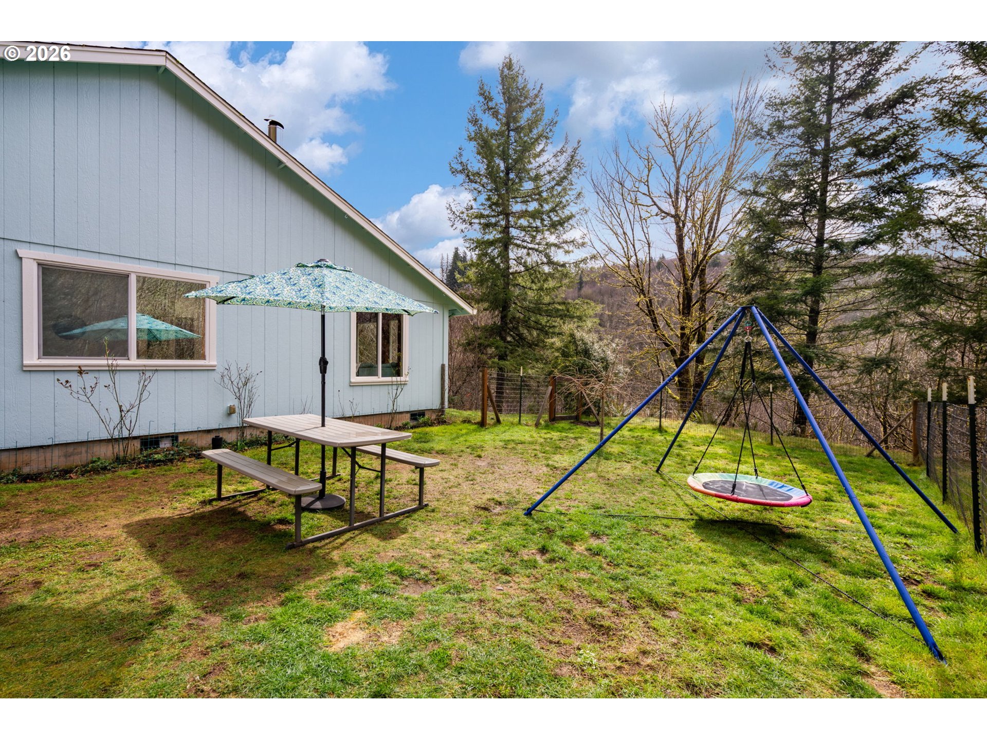 38220 Northeast Sunset Falls Road Yacolt, WA 98675 - Photo 31 of 40 a view of a house with a backyard and a slide