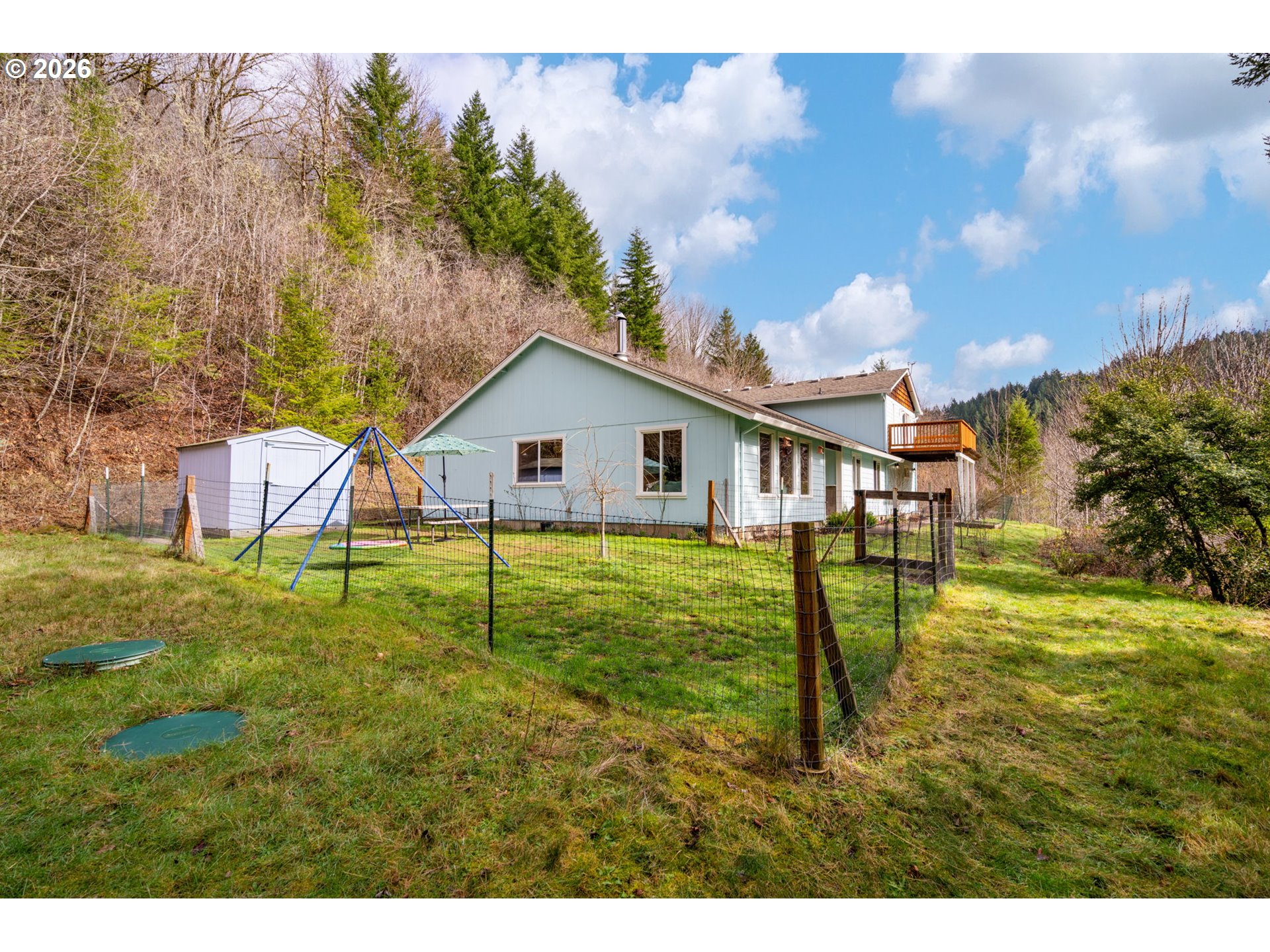 38220 Northeast Sunset Falls Road Yacolt, WA 98675 - Photo 32 of 40 a backyard of a house with table and chairs