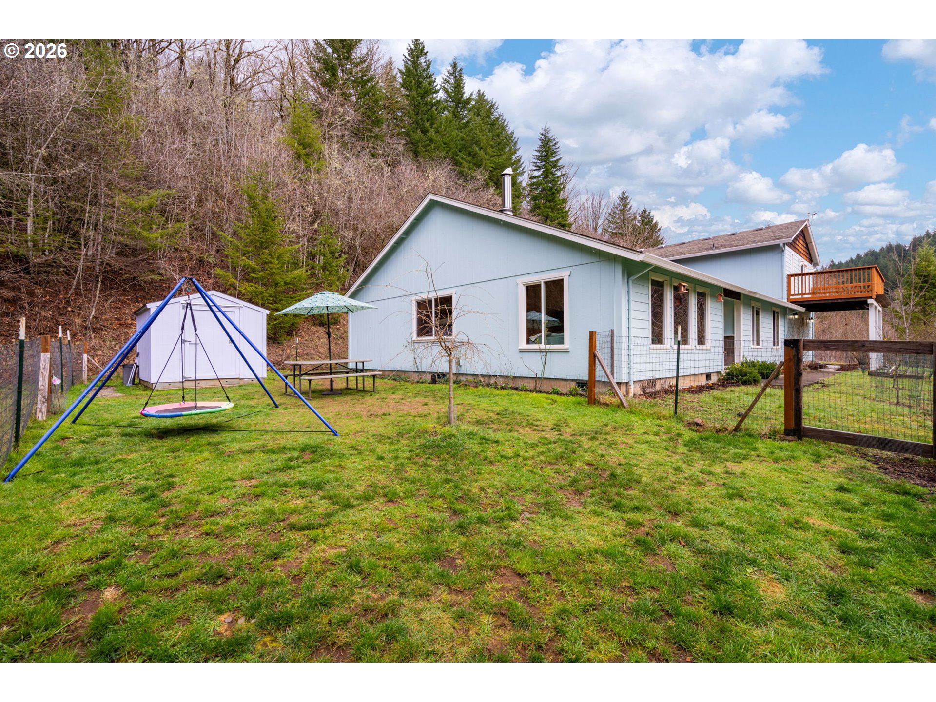 38220 Northeast Sunset Falls Road Yacolt, WA 98675 - Photo 37 of 40 a view of a house with a yard and sitting area