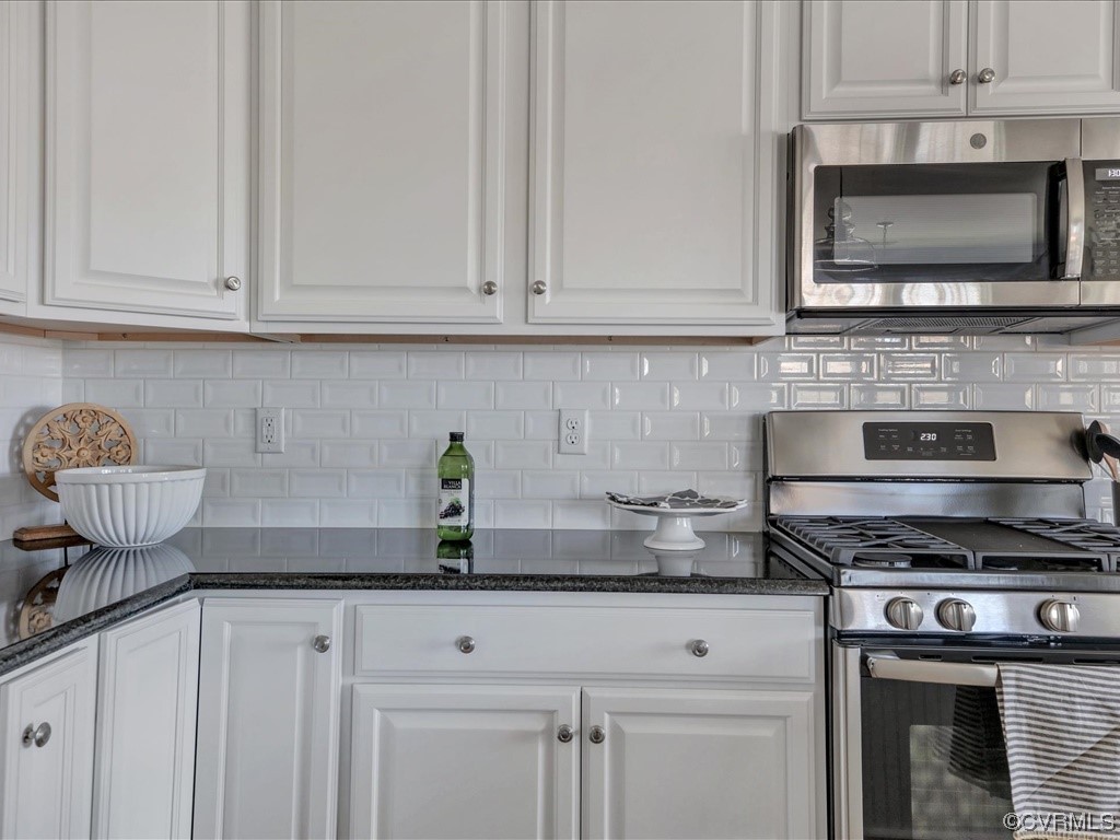 12806 Deep Wl Road Midlothian, VA 23112 - Photo 7 of 46 a kitchen with granite countertop white cabinets and stainless steel appliances