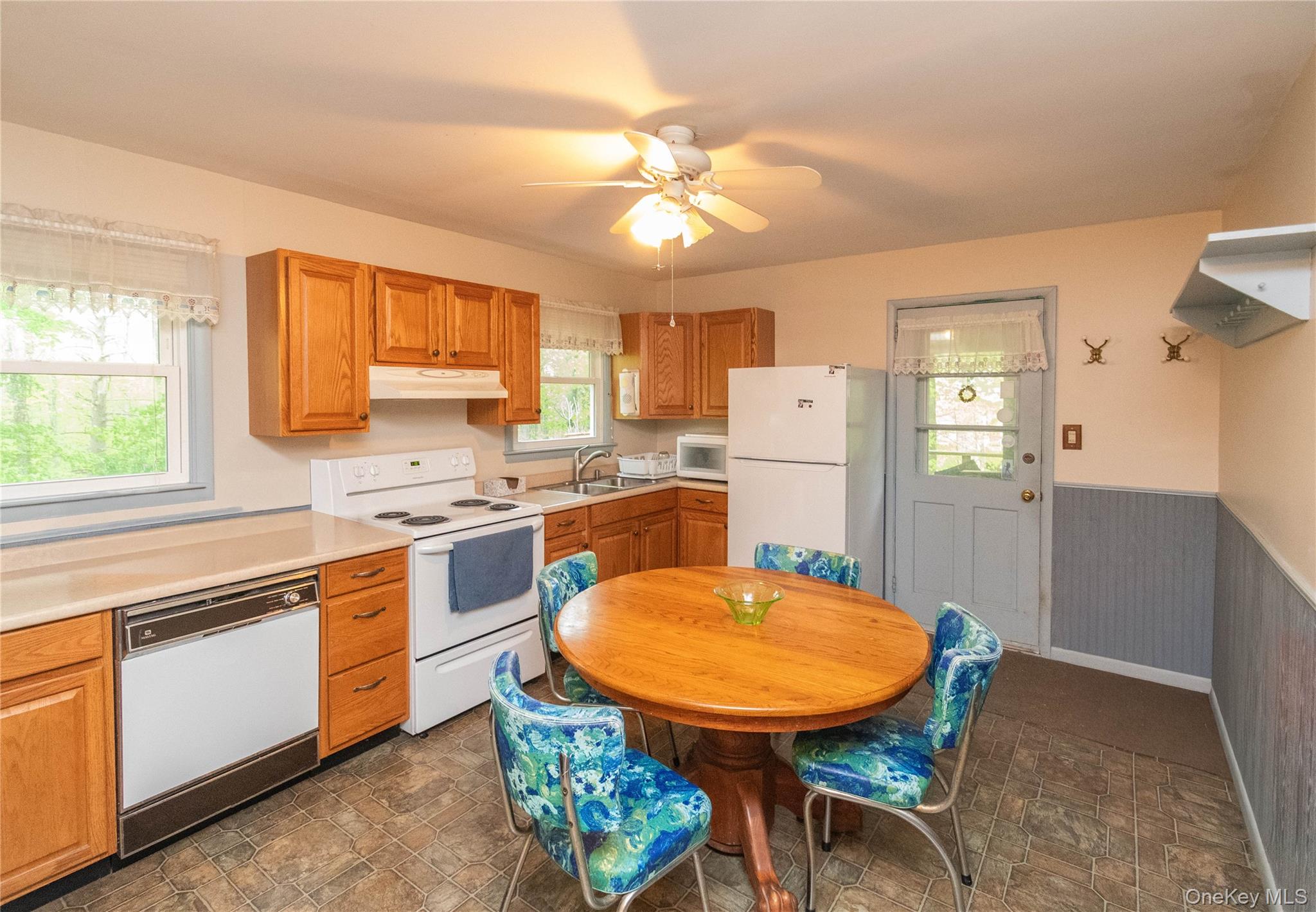 543 Dosen Road Middletown, NY 10940 - Photo 10 of 25 Eat in Kitchen featuring wood cabinetry, laminate countertops, vinyl flooring, and a ceiling fan