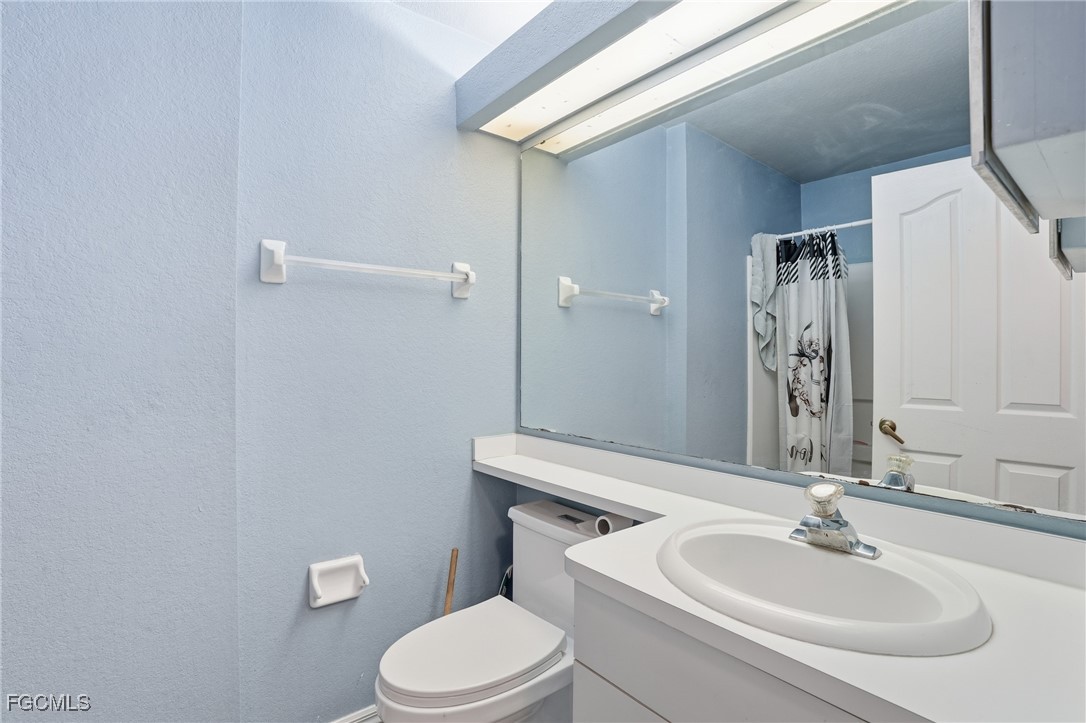 4480 20th Street Northeast Naples, FL 34120 - Photo 12 of 18 a bathroom with a sink a toilet and shower