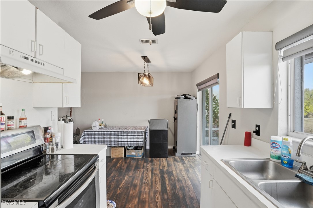 4480 20th Street Northeast Naples, FL 34120 - Photo 5 of 18 a kitchen with a sink a stove and cabinets