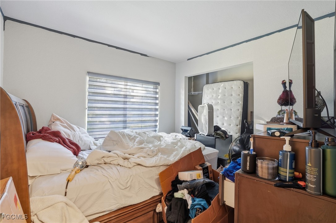 4480 20th Street Northeast Naples, FL 34120 - Photo 10 of 18 a bed sitting in a bedroom next to a window