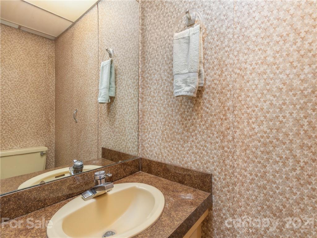 113 Possum Ridge Road Canton, NC 28716 - Photo 11 of 24 a bathroom with a sink and a mirror