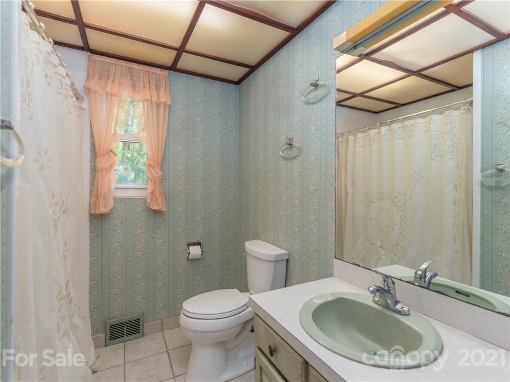 113 Possum Ridge Road Canton, NC 28716 - Photo 13 of 24 a bathroom with a sink a toilet and shower