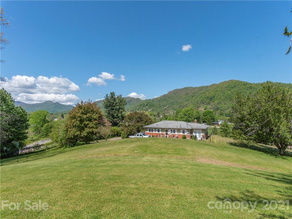 113 Possum Ridge Road Canton, NC 28716 - Photo 21 of 24 a view of a lake with a mountain in the background