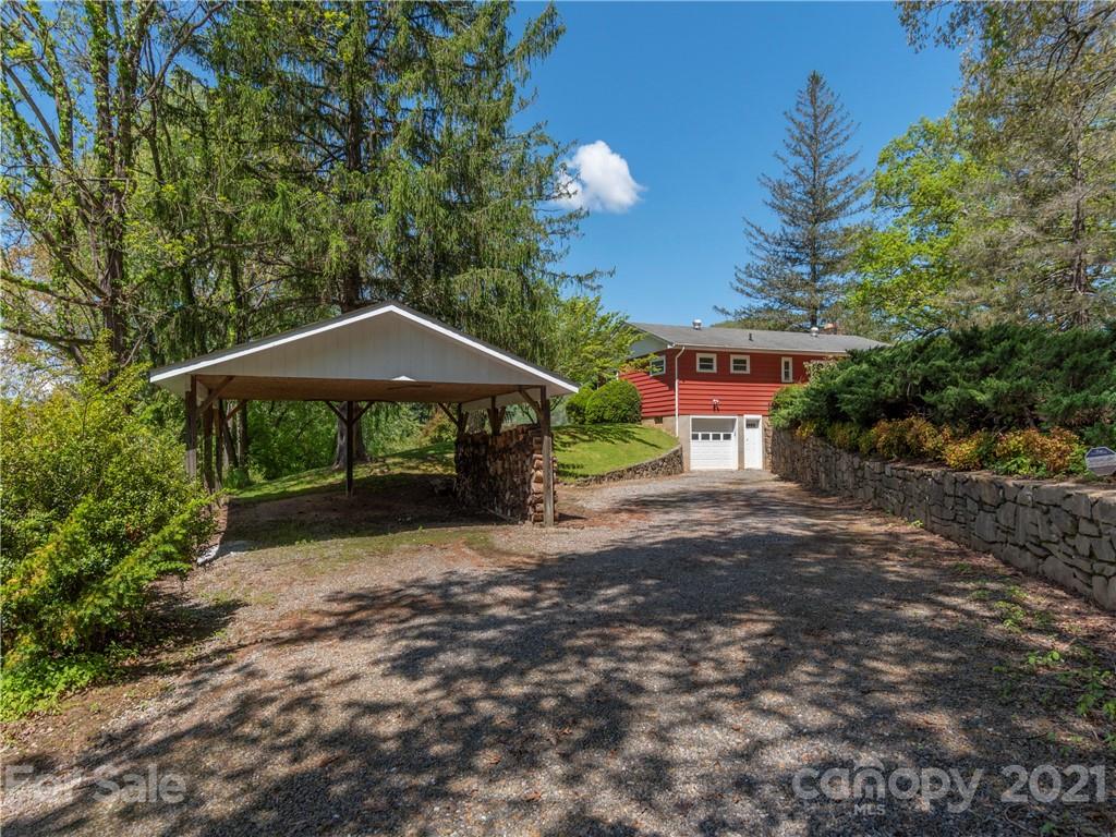 113 Possum Ridge Road Canton, NC 28716 - Photo 24 of 24 a backyard of a house with table and chairs under an umbrella