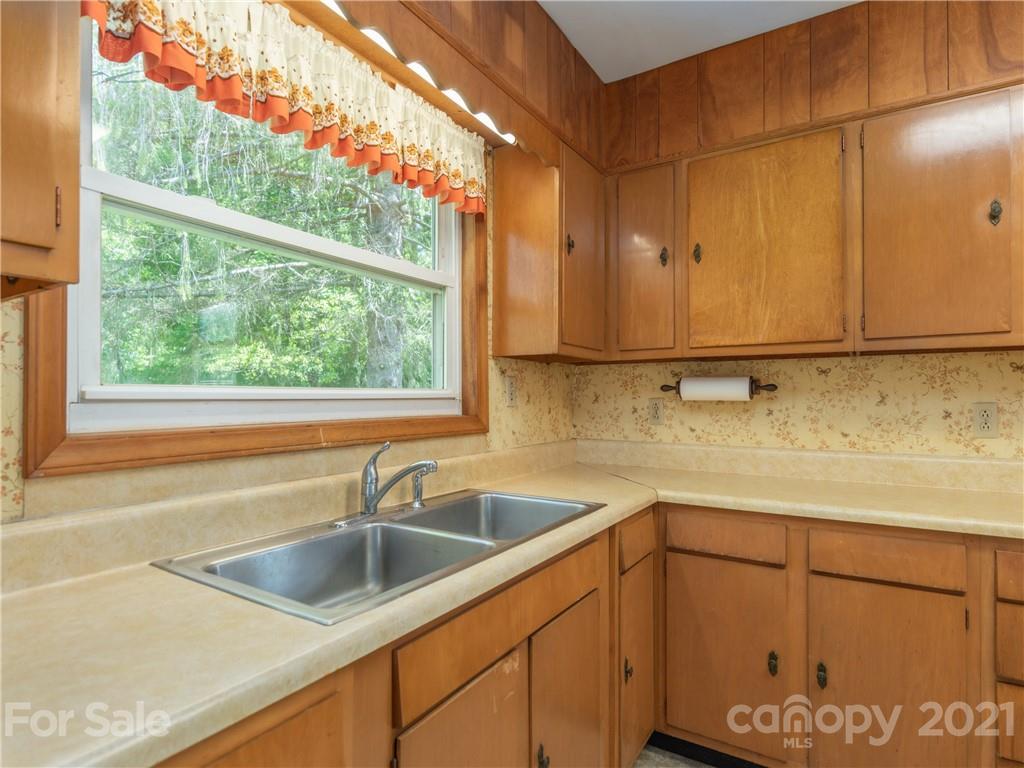 113 Possum Ridge Road Canton, NC 28716 - Photo 7 of 24 a kitchen with a sink and cabinets
