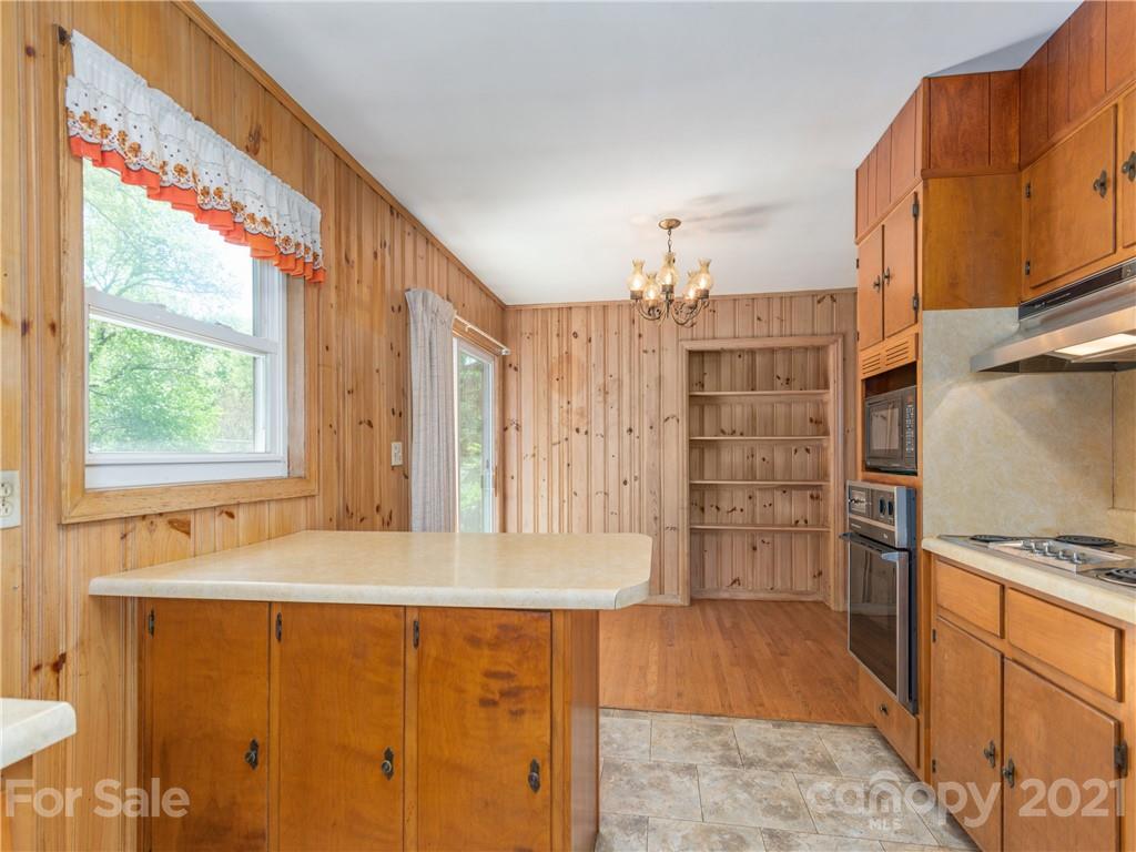 113 Possum Ridge Road Canton, NC 28716 - Photo 8 of 24 a kitchen with stainless steel appliances granite countertop a refrigerator and a sink