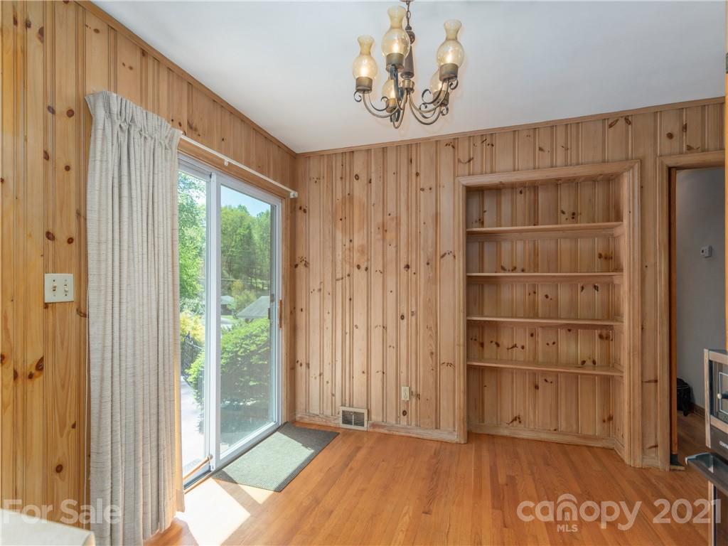 113 Possum Ridge Road Canton, NC 28716 - Photo 9 of 24 a view of a room with a window and wooden walls