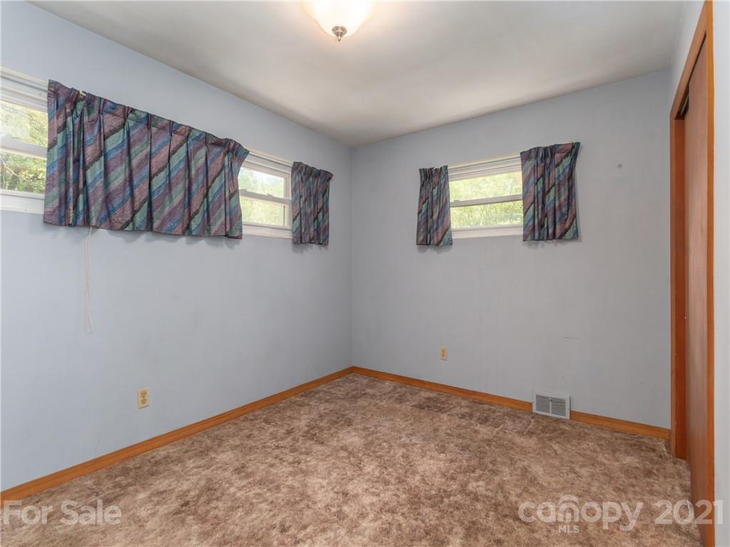 113 Possum Ridge Road Canton, NC 28716 - Photo 10 of 24 a view of a room that has a window and dresser