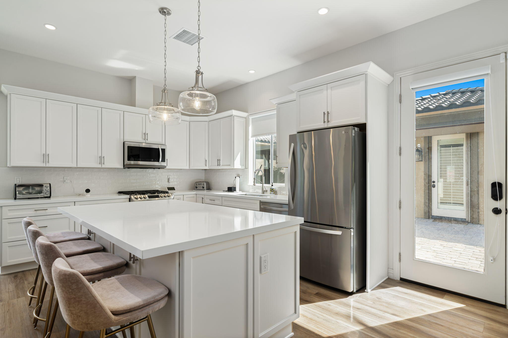 52455 Whispering Way La Quinta, CA 92253 - Photo 15 of 18 a kitchen with stainless steel appliances a refrigerator sink and microwave