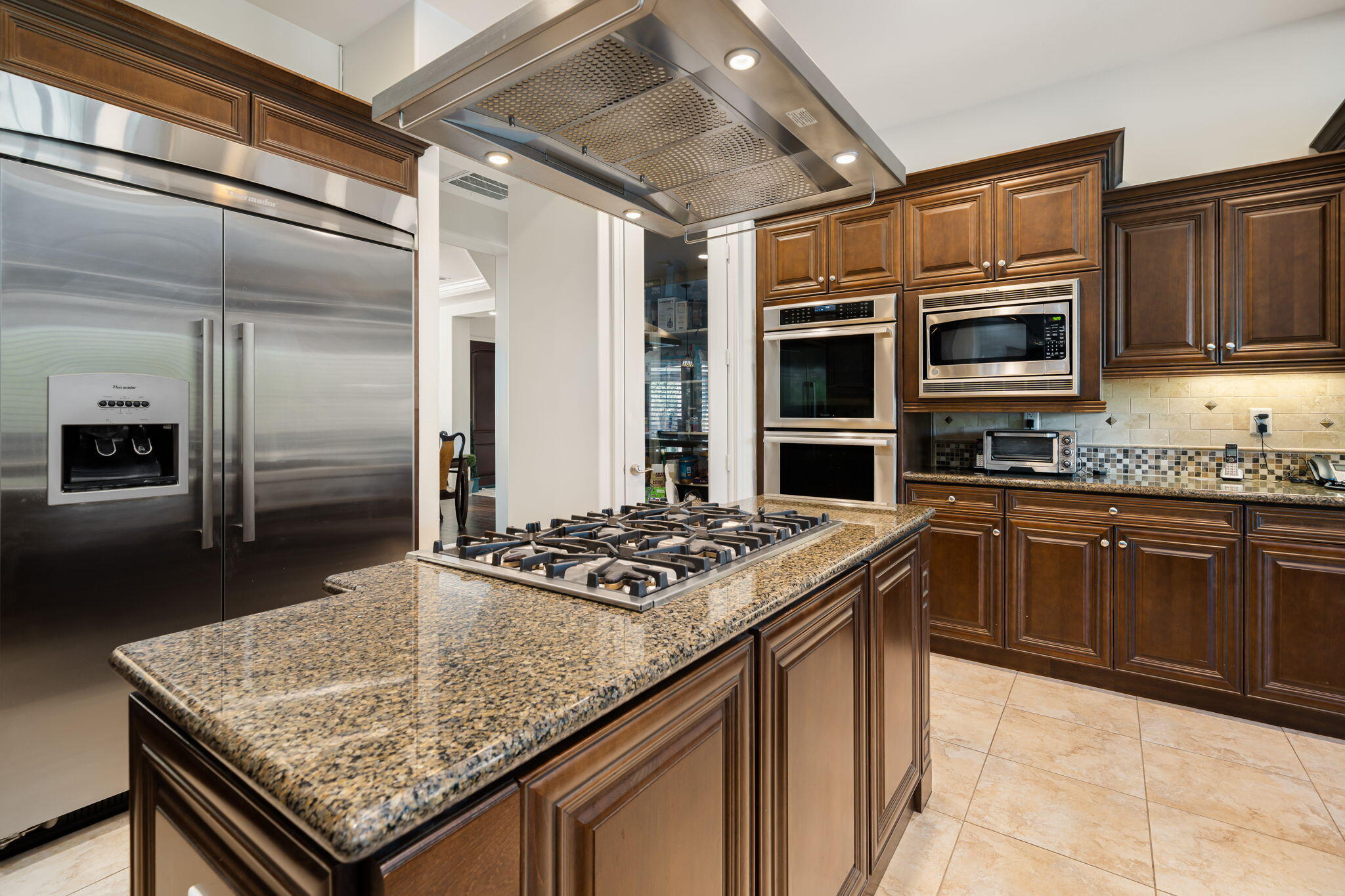 52455 Whispering Way La Quinta, CA 92253 - Photo 9 of 18 a kitchen with stainless steel appliances granite countertop a sink and cabinets