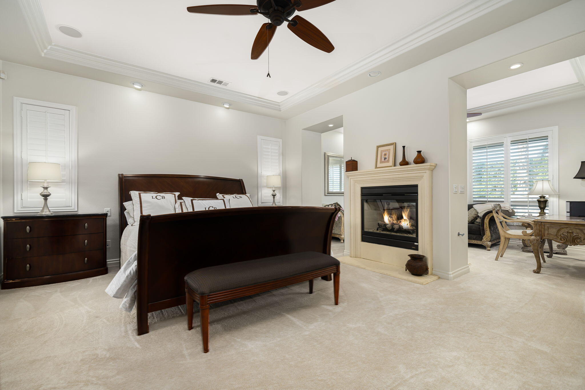 52455 Whispering Way La Quinta, CA 92253 - Photo 10 of 18 a bedroom with furniture and a fireplace