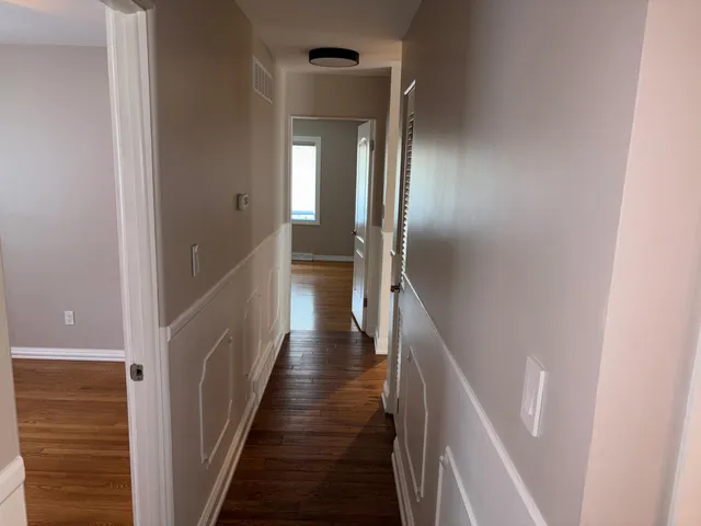 a view of a hallway with the wooden floor