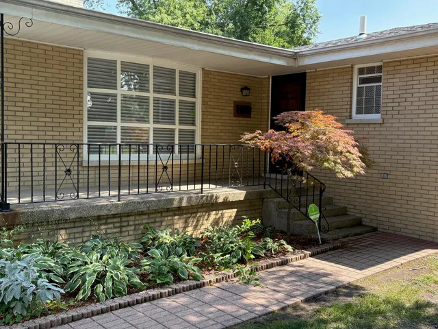 a front view of a house with a garden