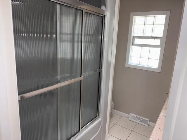 a bathroom with a glass shower door
