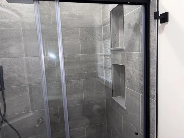 a bathroom with a glass shower door
