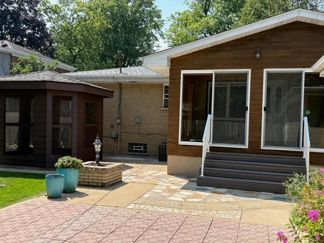 a view of a house with sitting area and a garden