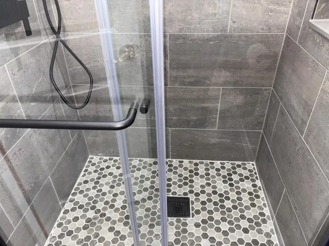 a bathroom with a glass door shower