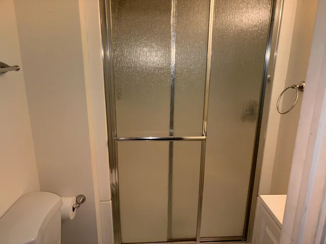 a bathroom with a glass shower door