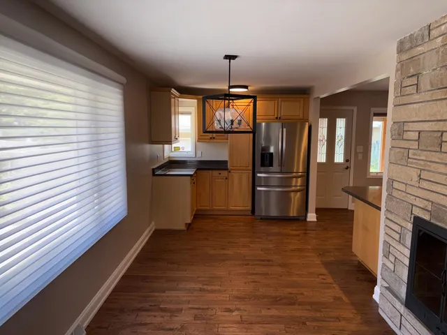 a kitchen with stainless steel appliances granite countertop a refrigerator and a sink