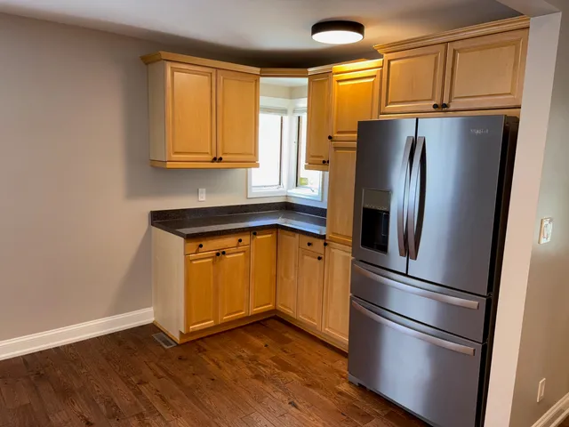 a kitchen with stainless steel appliances granite countertop a refrigerator microwave and sink