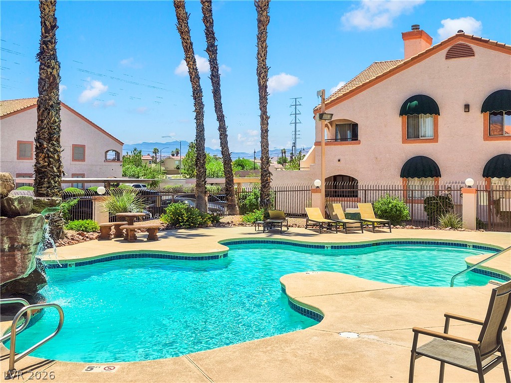 7570 West Flamingo Road, Unit 115 Las Vegas, NV 89147 - Photo 25 of 34 A tranquil oasis awaits, offering a refreshing pool and ample space for sunbathing.