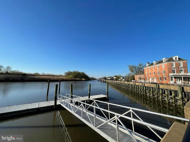 a view of a balcony with wooden floor and fence