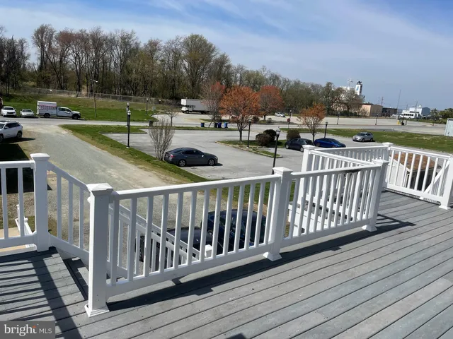 a view of a balcony with wooden floor and fence