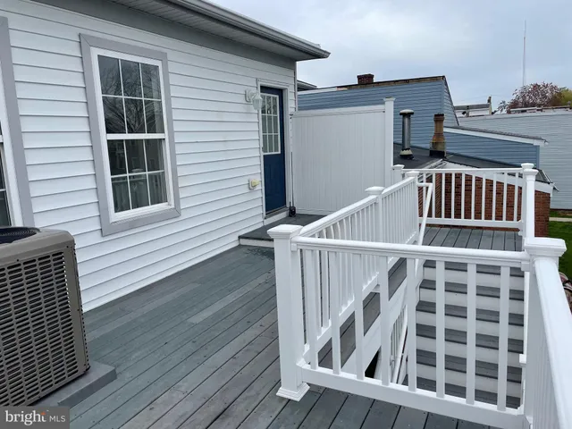 a view of a balcony with wooden floor and fence
