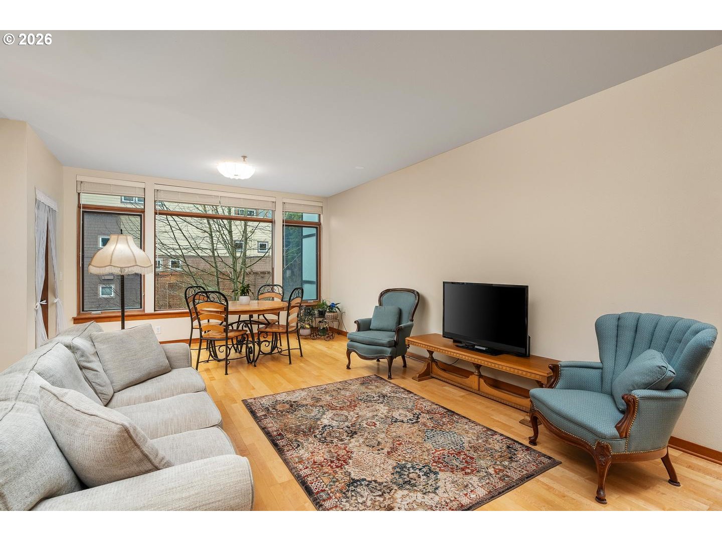 7910 Southwest 31st Avenue, Unit 203 Portland, OR 97219 - Photo 3 of 27 a living room with furniture and a flat screen tv