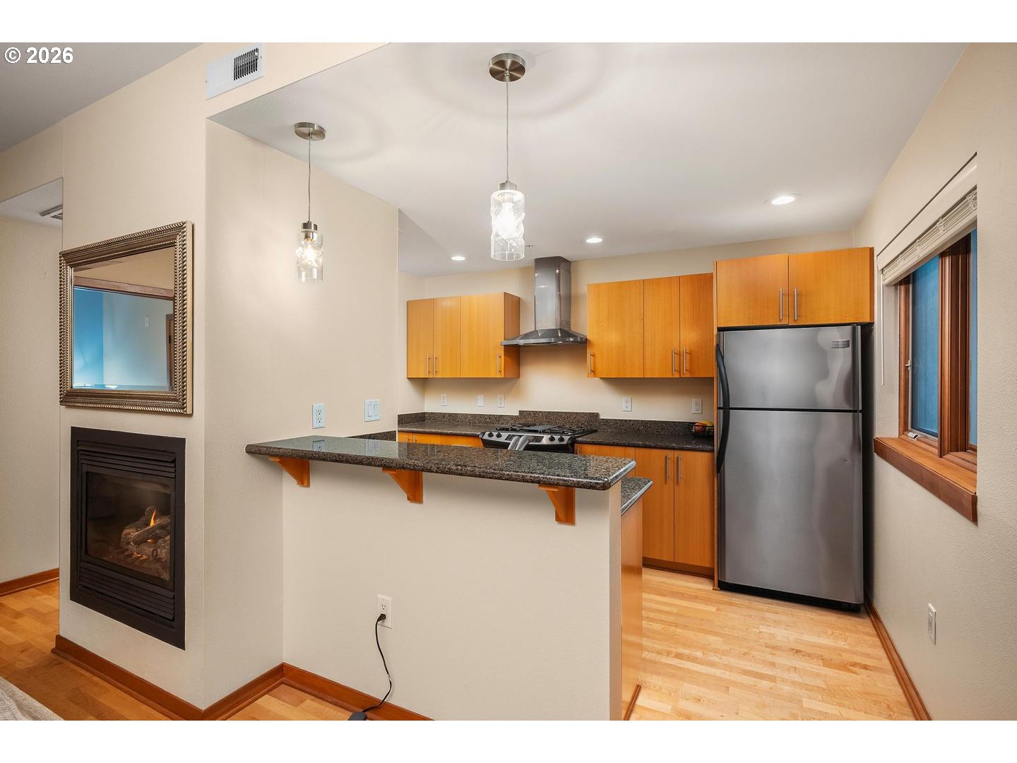 7910 Southwest 31st Avenue, Unit 203 Portland, OR 97219 - Photo 6 of 27 a kitchen with stainless steel appliances granite countertop a refrigerator a sink and a stove