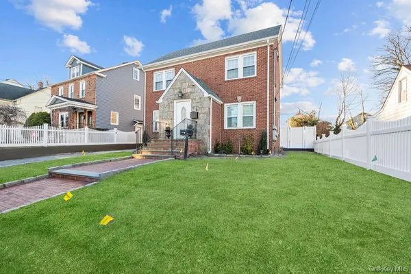 a front view of house with yard and outdoor seating