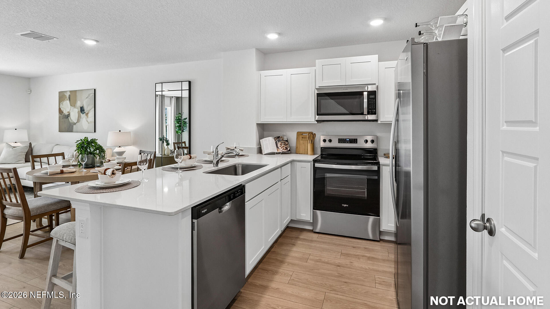 3600 Prancer Point Middleburg, FL 32068 - Photo 5 of 38 a kitchen with stainless steel appliances a sink a stove a microwave a refrigerator and cabinets