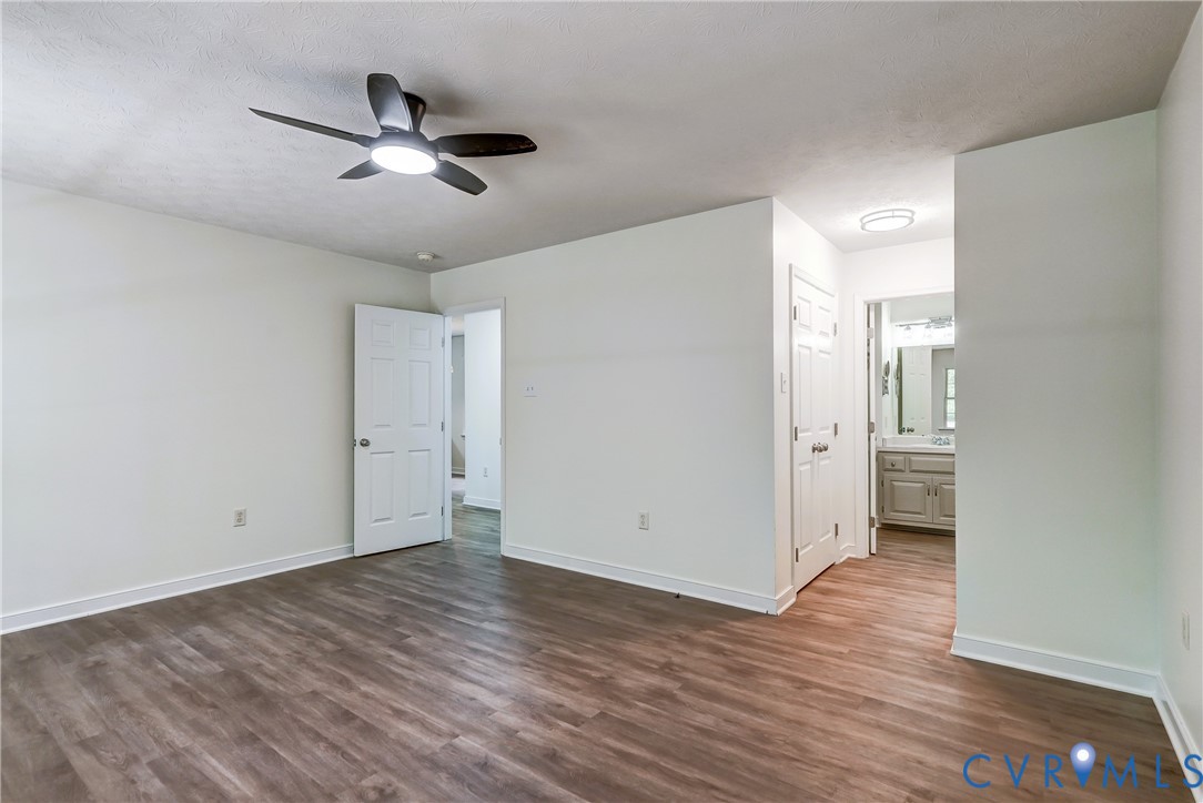 3820 Mt Pleasant Road Providence Forge, VA 23140 - Photo 13 of 40 an empty room with wooden floor and a ceiling fan
