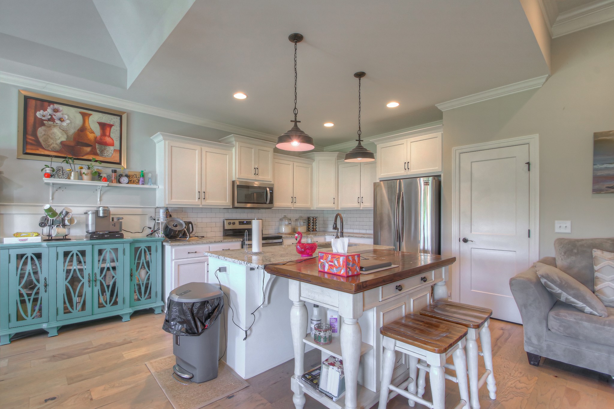 121 Flat Woods Road Lebanon, TN 37090 - Photo 5 of 39 a kitchen with stainless steel appliances kitchen island granite countertop a dining table chairs sink and white cabinets