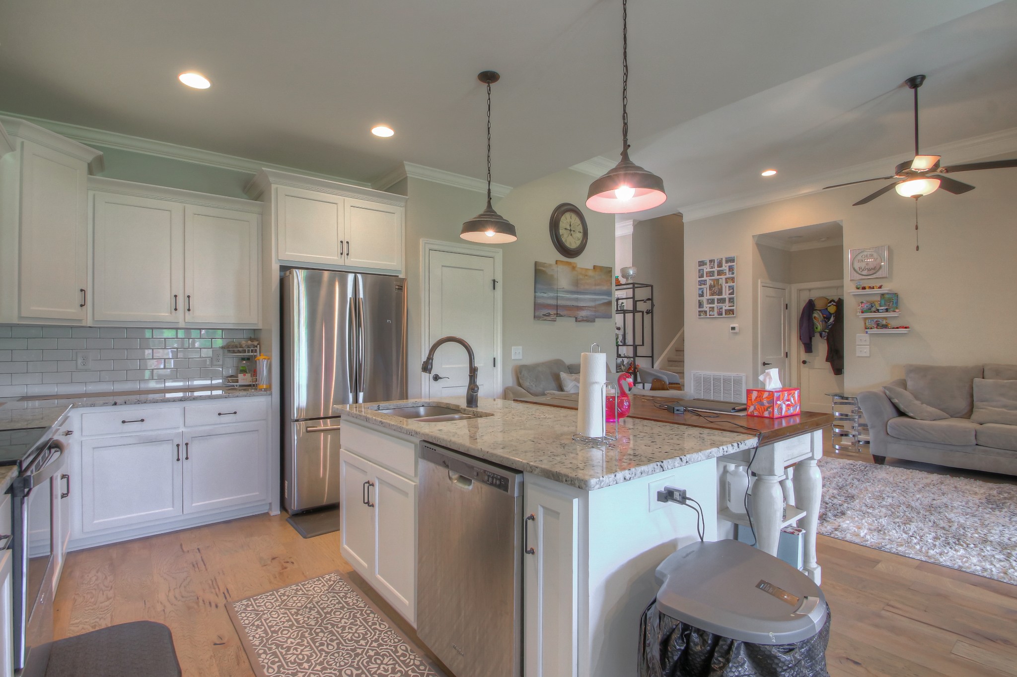 121 Flat Woods Road Lebanon, TN 37090 - Photo 7 of 39 a kitchen with stainless steel appliances granite countertop a kitchen island a stove a sink a refrigerator and a dining table with granite countertop