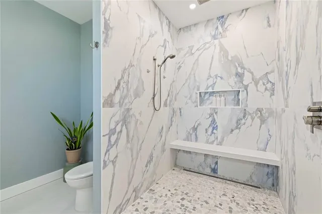 a bathroom with a shower curtain and a toilet