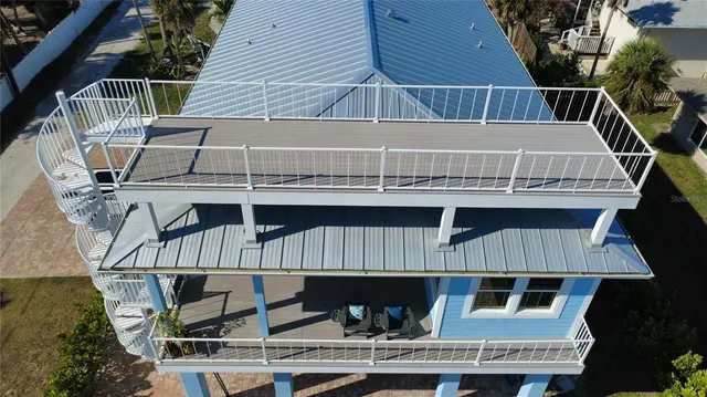 a view of house with roof deck and deck