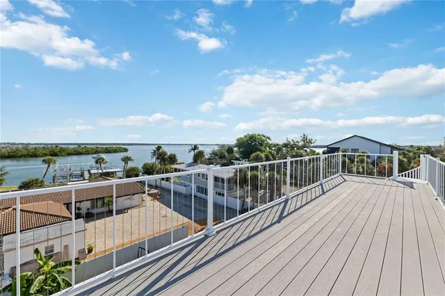a view of a balcony with wooden floor and city view
