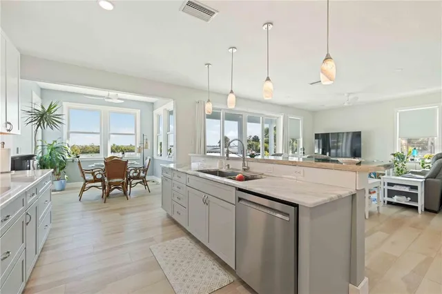 a room with lots of white furniture and couches