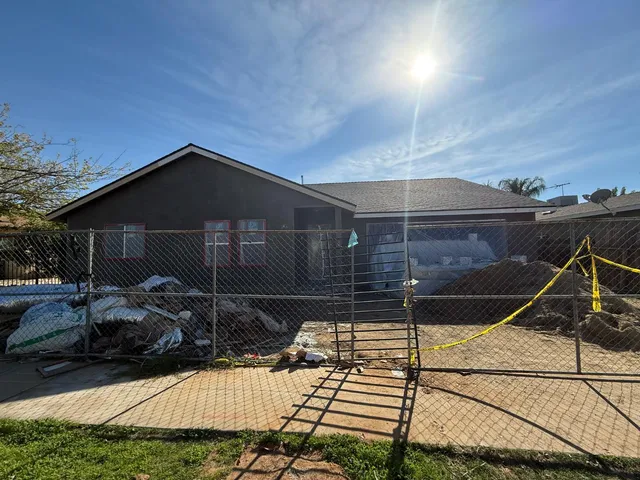 a backyard of a house with table and chairs