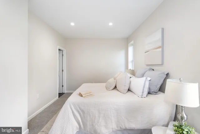 a bedroom with a bed and a night stand