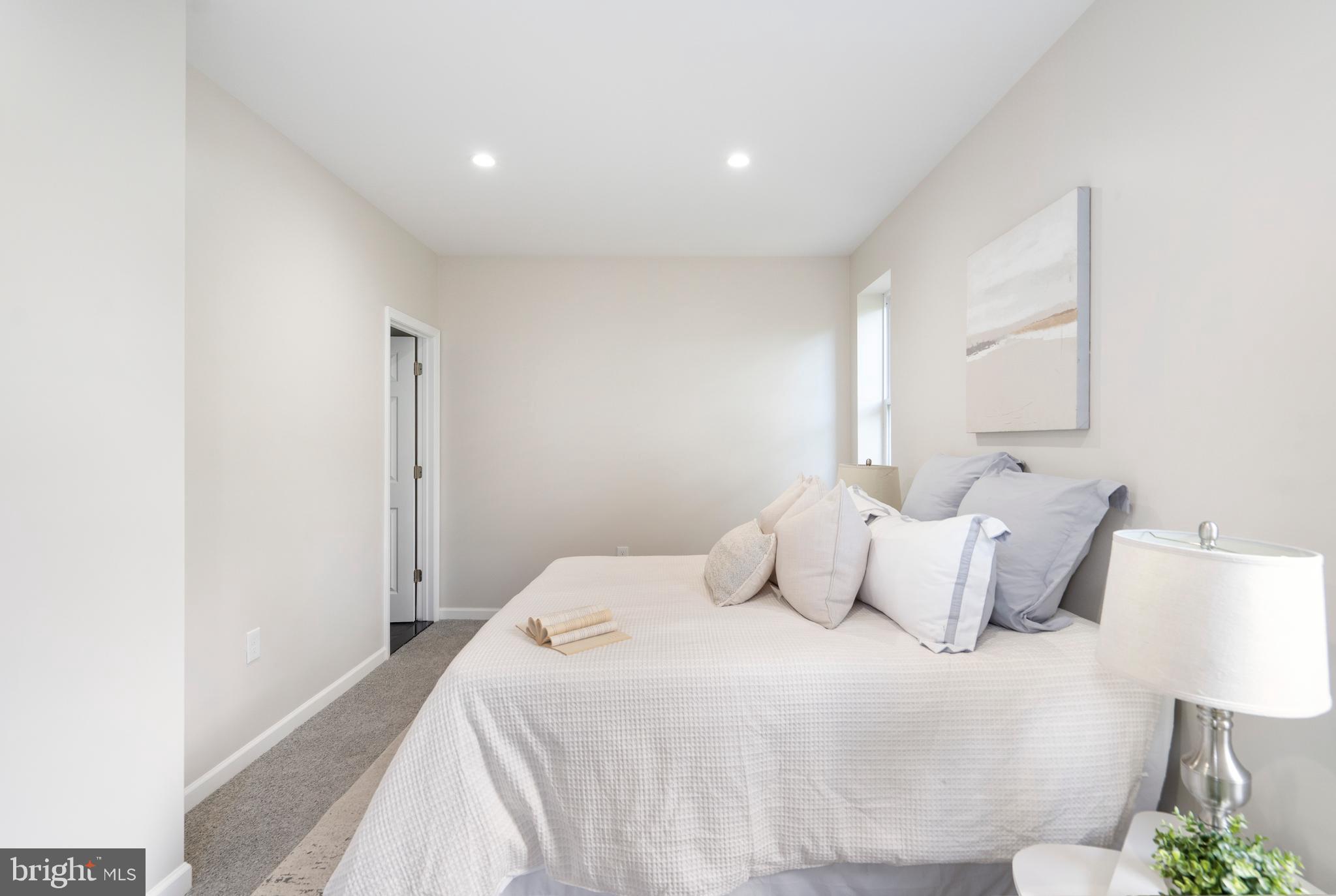 4011 Ridgewood Avenue Baltimore, MD 21215 - Photo 18 of 35 a bedroom with a bed and a night stand